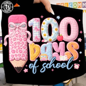 May include: Black t-shirt with a colorful graphic celebrating "100 Days of School." The design includes a large pencil, numbers, and letters in various patterns and colors, along with a school bus and an apple.