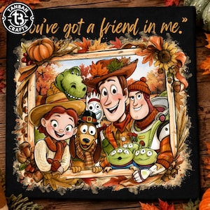 May include: A black fabric print featuring a group of cartoon characters in a wooden frame decorated with autumn leaves, pumpkins, and sunflowers. The text "You've got a friend in me." is printed in gold script at the top of the design.