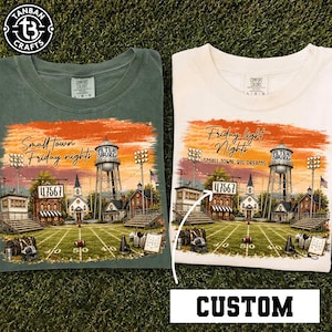 May include: Two t-shirts, one olive green and one cream, featuring a graphic of a football field, a water tower labeled Petersburg, and buildings. The left shirt says Small Town Friday nights, while the right shirt says Friday light Nights and SMALL TOWN. BIG DREAMS, with a white arrow pointing to a sign reading 47567.