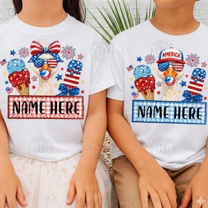 May include: White t-shirts with patriotic designs. One shirt features a red and blue bow, ice cream cones, and the text "NAME HERE" in a red frame. The other shirt has a blue frame and the word "AMERICA" on a hat.