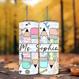 May include: Two stainless steel tumblers with a pencil and eraser design, featuring the name "Ms. Sophia" on a lined paper background. The design includes colorful geometric patterns, flowers, and science-themed graphics.