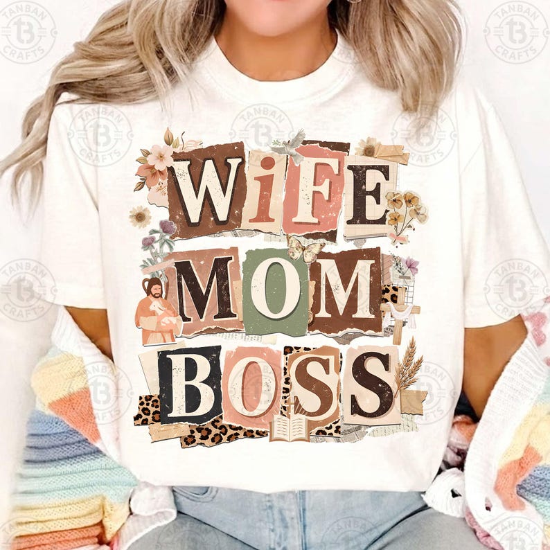 May include: White t-shirt with the words "WIFE MOM BOSS" in a collage style design. The design incorporates floral elements, a butterfly, and a leopard print pattern. The shirt is a casual, everyday wear item.