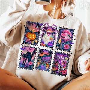 Peut inclure: Un sweat-shirt &agrave; col rond couleur cr&egrave;me orn&eacute; d'un imprim&eacute; graphique compos&eacute; de six illustrations rectangulaires en forme de timbres-poste. Les motifs incluent une citrouille, un fant&ocirc;me avec un n&oelig;ud rose, une pleine lune, un chat noir et un squelette.