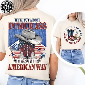 May include: Cream-colored t-shirt featuring a graphic with a cowboy hat and boots in red, white, and blue, with the text "WE'LL PUT A BOOT IN YOUR ASS, IT'S THE AMERICAN WAY." Another shirt shows a similar design with the text "RED, WHITE, AND BLUE, COURTESY OF".