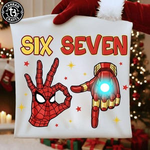 May include: White fabric bag with the words "SIX SEVEN" in yellow and red. The bag features illustrations of Spider-Man's hand making an "OK" gesture and Iron Man's hand with a glowing center. Red stars and yellow starbursts are scattered around the design.