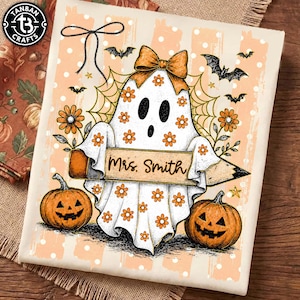 May include: A white fabric print featuring a ghost character with orange daisy patterns, wearing an orange bow, and holding a pencil with the text Mrs. Smith. The design includes orange pumpkins, black bats, spider webs, and orange stripes with white dots.