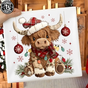 May include: A square canvas print featuring a Highland cow wearing a plaid Christmas hat and scarf, adorned with string lights and ornaments. The cow is brown with large horns and is surrounded by snowflakes and pine branches.