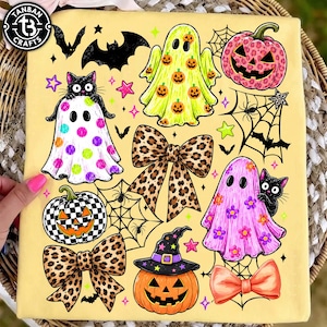 May include: A pale yellow fabric featuring a Halloween-themed graphic print. The design includes ghosts with pumpkin, polka dot, and floral patterns, jack-o'-lanterns with leopard and checkerboard prints, leopard print bows, and black cats.