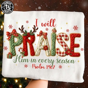 May include: White Christmas-themed decorative pillow with the words "I will PRAISE Him in every season Psalm 146:2". The word "PRAISE" is in a knitted style with Christmas decorations.