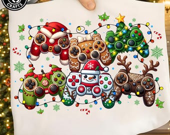 May include: A white fabric surface featuring a graphic print of six video game controllers decorated for the holidays. The controllers are styled as a Santa suit, gingerbread cookie, Christmas tree, elf, snowman, and reindeer, all connected by string lights.
