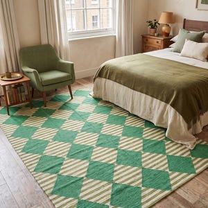 May include: A rectangular area rug featuring a repeating diamond pattern in alternating shades of green and cream. The design consists of solid green diamonds interspersed with cream and green striped diamonds, creating a geometric visual effect.