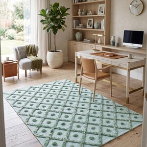 May include: A rectangular area rug featuring a light mint green and white geometric diamond pattern with raised tufted circular accents at the center of each diamond shape, covering a portion of a light-colored wooden floor in a home office.