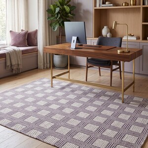 May include: A rectangular area rug featuring a repeating geometric pattern of dark purple and off-white squares. The rug has a textured, woven appearance with a consistent grid design that covers the entire surface, providing a neutral foundation.