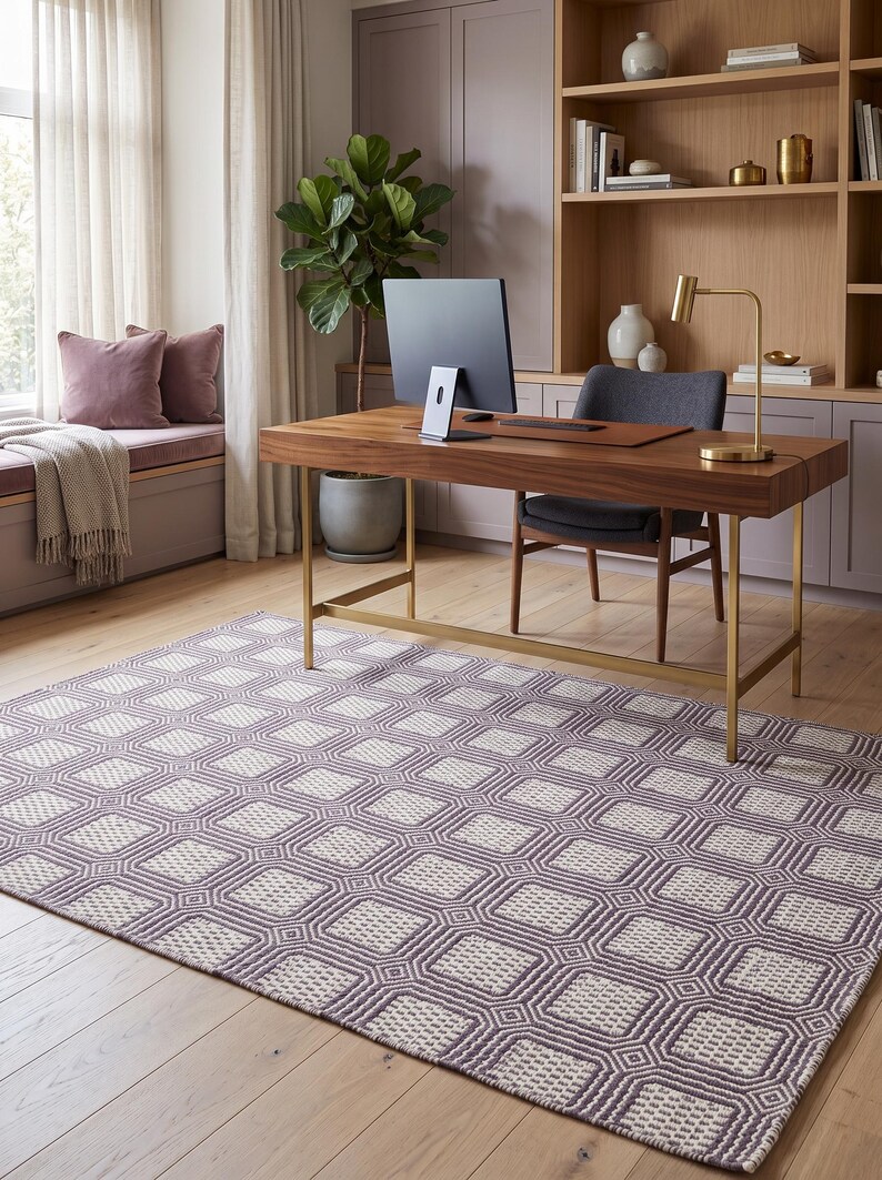 May include: A rectangular area rug featuring a repeating geometric pattern of dark purple and off-white squares. The rug has a textured, woven appearance with a consistent grid design that covers the entire surface, providing a neutral foundation.