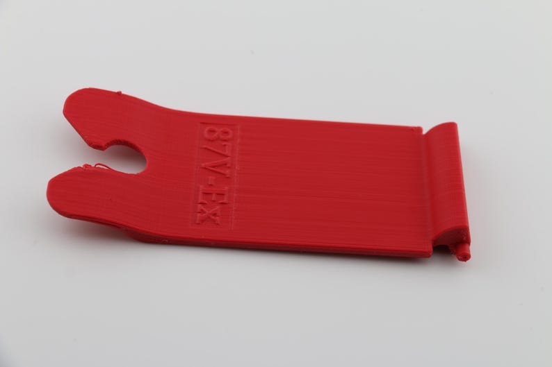 May include: Red plastic tool with a hook on one end and the text "B/V-EX" printed on the other end.