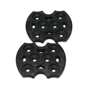 May include: Two black, circular objects with multiple small, round holes arranged in a pattern. The objects have a unique, symmetrical design with curved edges and are set against a white background.