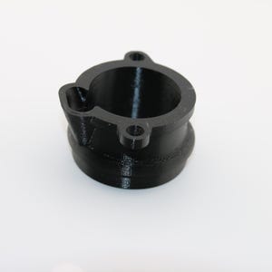 May include: A black plastic 3D printed adapter with a round opening. The adapter has a smooth, matte finish.