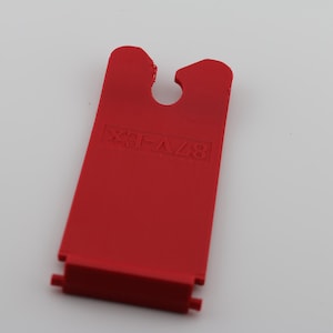 May include: Red plastic piece with a hole in the center and the text "EXTRA" printed on it.