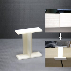 May include: White plastic shelf support bracket with a T-shaped design. The bracket is shown in two positions: one with the top of the bracket flush with the shelf and the other with the bracket installed on the shelf.