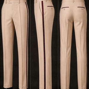 May include: Tan dress pants with a burgundy stripe down the side. The pants have a classic fit with a button closure and pockets. The pants are shown from multiple angles.