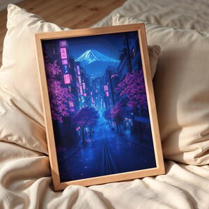 May include: A framed print of a digital painting depicting a street scene in Japan at night. The street is lined with buildings and cherry blossom trees. The mountain in the background is illuminated by a blue glow.