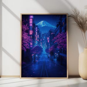 May include: A digital art print of a city street at night with a mountain in the background. The street is lined with buildings and trees with pink blossoms. The street is lit with neon lights and the sky is a deep blue.