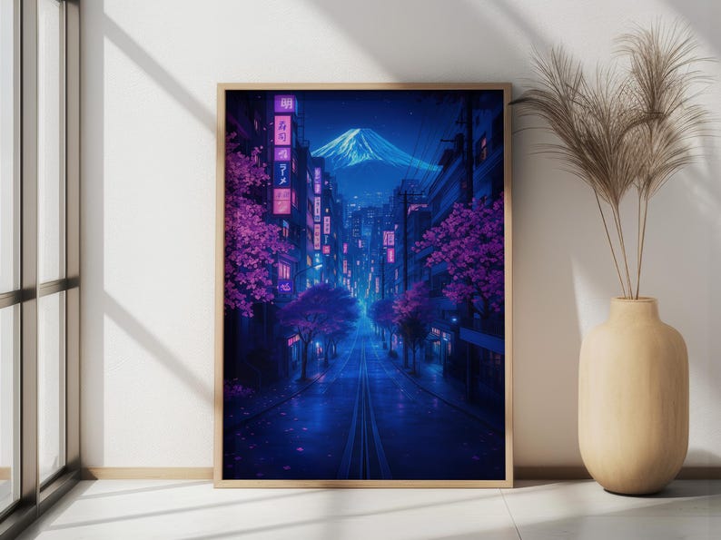 May include: A digital art print of a city street at night with a mountain in the background. The street is lined with buildings and trees with pink blossoms. The street is lit with neon lights and the sky is a deep blue.