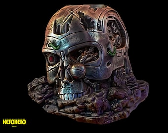 May include: A metallic skull sculpture with a detailed, intricate design. The skull is partially exposed, revealing a mechanical interior with wires and gears. The skull is resting on a rocky base.