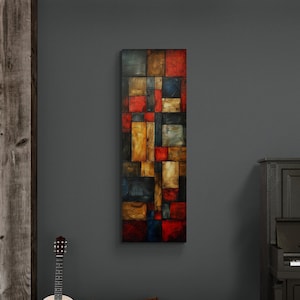 Könnte beinhalten: Ein modernes abstraktes Gemälde mit geometrischen Formen in Rot-, Gelb-, Blau- und Brauntönen hängt an einer dunkelgrauen Wand in einem Raum mit einem Klavier, zwei braunen Hockern und zwei Akustikgitarren.