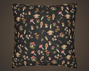 May include: Square cushion featuring a black background with a repeating pattern of various mushrooms, leaves, and small dots. The mushrooms are in shades of red, brown, yellow, and white.