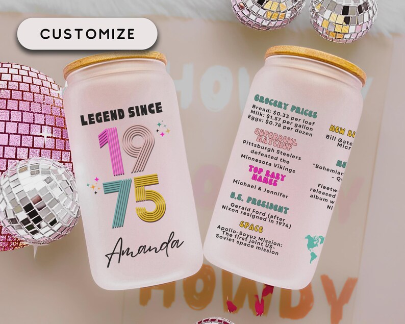 May include: Two frosted glass can-shaped tumblers with bamboo lids. One reads "LEGEND SINCE 1975 Amanda" in colorful text. The other lists 1975 events like grocery prices, Super Bowl, and space missions. The word "CUSTOMIZE" is at the top.