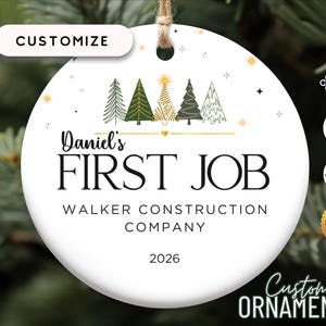 May include: White ceramic Christmas ornament with a green, gold, and white Christmas tree design. The ornament says "Daniel's First Job Walker Construction Company 2026".