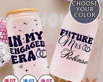 May include: Two frosted glass tumblers with wooden lids. One reads "IN MY ENGAGED ERA" with a ring graphic, the other says "FUTURE Mrs. Robinson". The image includes a "CHOOSE YOUR COLOR" graphic.