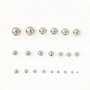 May include: A collection of polished silver-tone metal beads arranged in three horizontal rows, organized by size from largest to smallest. Each spherical bead features a central hole, showcasing a smooth, reflective surface and a metallic finish.
