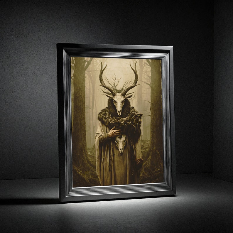 May include: Framed artwork featuring a figure with a deer skull mask and antlers, clad in a long robe, holding another skull. The artwork has a dark, forest-like background with muted tones, and is set in a black frame.