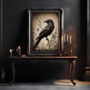 May include: A black and white framed print of a crow perched on a branch. The print is set against a dark background with candles on a table in front of it.