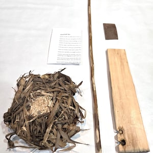May include: Hand drill fire starting kit with a wooden spindle, fireboard, and a nest of tinder. Instructions for hand drill fire starting are included on a white card.