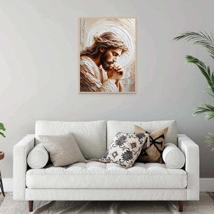 May include: A painting of a man with a crown of thorns, praying with his hands clasped together. The painting is in a light brown frame and has a white background.