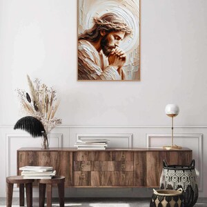 May include: A painting of Jesus Christ with a crown of thorns, praying with his hands clasped together. The painting is done in a painterly style with a light brown and white color palette.