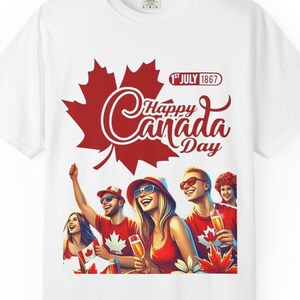 May include: White t-shirt with a red maple leaf and the words "Happy Canada Day" in a script font. The shirt features an illustration of people celebrating, holding drinks, and wearing red and white.