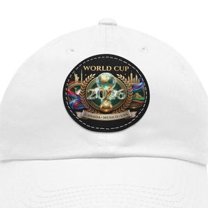 May include: White baseball cap featuring a circular patch with the text "WORLD CUP 2026" and the flags of Canada, Mexico, and the USA. The patch includes a gold trophy and the words "CANADA MEXICO USA".