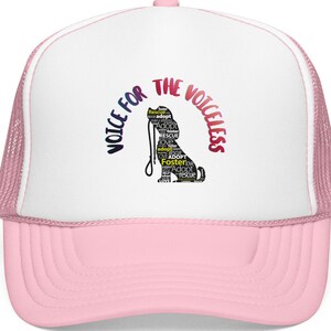 May include: A pink and white trucker hat with the text "Voice for the Voiceless" in a curved design. A black silhouette of a dog is in the center, with words like "adopt" and "rescue" inside the dog's shape.