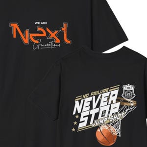 May include: A black t-shirt featuring a front graphic with orange text reading "WE ARE Next Generations" and a back graphic with white and orange text reading "NO FAILURE NEVER STOP JUMP SHOT" alongside a basketball and a basketball hoop net.