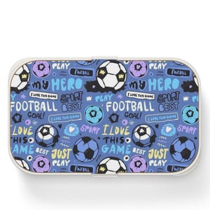 May include: A rectangular lunch box with a blue background featuring a repeating pattern of soccer balls, purple circles, and text including "MY HERO," "FOOTBALL," "GOAL," "I LOVE THIS GAME," "SPORT," "BEST," and "JUST PLAY" in white and light blue.