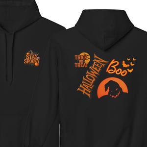 May include: A black hooded sweatshirt featuring a small graphic on the front chest with the text "STAY SPOOKY" and pumpkins. The back displays a large orange graphic with the text "TRICK OR TREAT", "HALLOWEEN", and "Boo" alongside bats and a character silhouette.