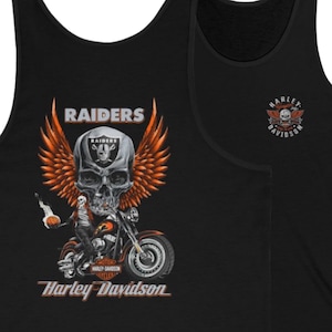 May include: A black tank top featuring a graphic of a skull with orange wings, a motorcycle, and the text Raiders and Harley-Davidson. A smaller Harley-Davidson logo with a skull is printed on the upper chest area of the garment.