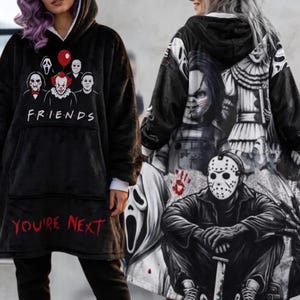 May include: A black oversized hooded sweatshirt featuring a front graphic of horror movie characters with the text FRIENDS and YOU'RE NEXT in red. The back displays a large, detailed black and white collage of iconic horror film villains.