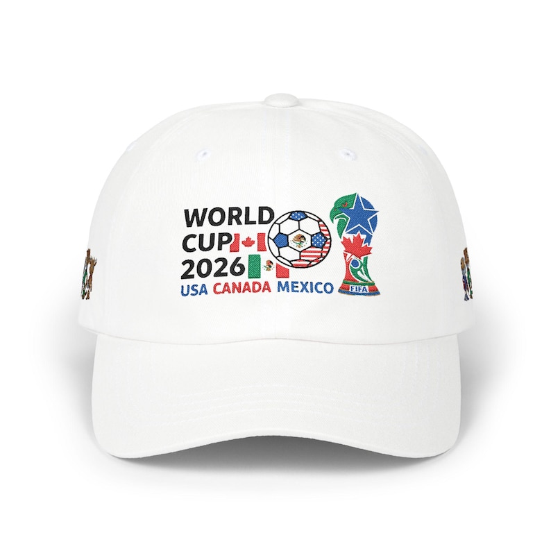 May include: White baseball cap featuring the text "WORLD CUP 2026" with flags of USA, Canada, and Mexico. A soccer ball graphic and the FIFA trophy are also displayed. The cap has a curved brim.