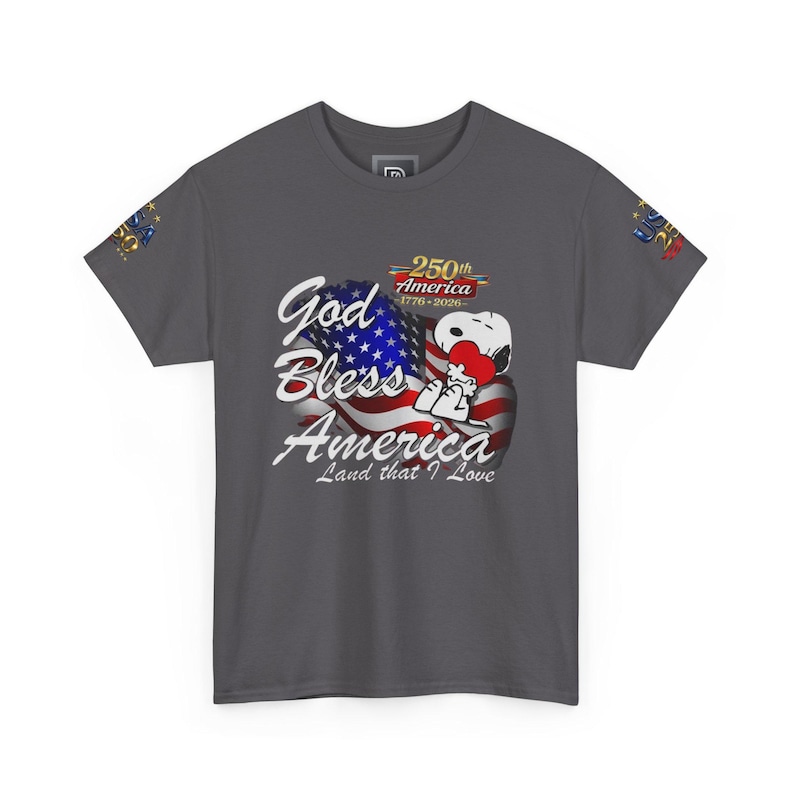May include: Dark gray t-shirt featuring Snoopy holding a heart in front of an American flag. The shirt includes the text "God Bless America, Land that I Love" and "250th America 1776-2026".