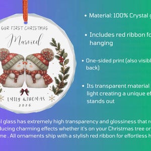 May include: A round crystal glass Christmas ornament featuring a printed illustration of two snowmen wearing red and green hats and scarves. The text reads Our First Christmas Married, Emily & Thomas, and 2026. It includes a red hanging ribbon.